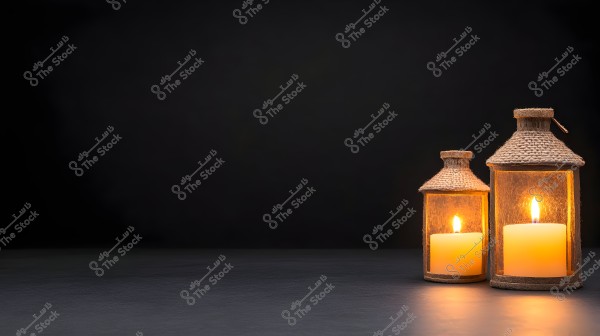 Image of two lanterns lit with candles inside on a dark background. The lanterns are made of glass and decorated with wooden details in a traditional style, glowing with warm candlelight.
