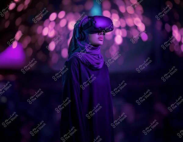 An image of a woman wearing a hijab and virtual reality goggles, standing against a background illuminated with purple lights, creating a futuristic ambiance. The woman is dressed in a long abaya, suggesting she might be from a Gulf country like Saudi Arabia. The focus is on the virtual reality experience in an innovative setting.