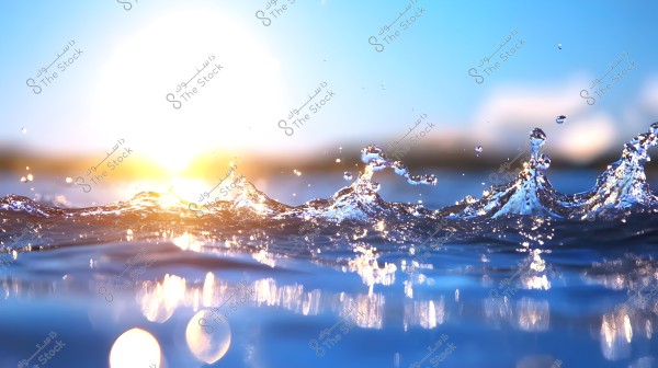 Water scene featuring small waves splashing into the air at sunrise or sunset. The golden light of the sun reflects and blends with the blue of the water and sky, creating a bright sparkle and a calm, serene atmosphere.