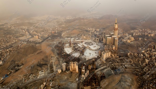 Aerial view of Mecca showing the Grand Mosque and the Clock Tower in the center of the city with surrounding areas.