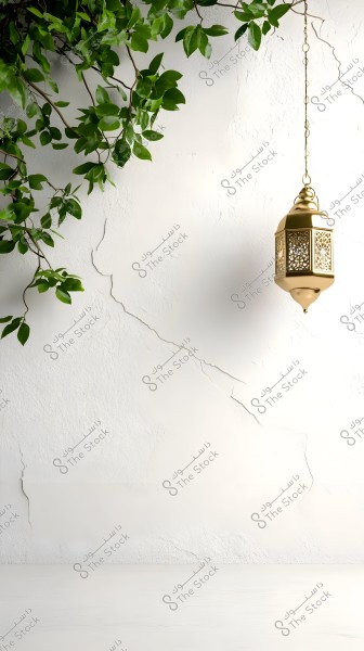 A traditional golden lantern hanging from a chain against a cracked white wall background. A branch of green leaves extends from the upper left corner, adding a natural touch to the scene, creating a serene and contemporary atmosphere.