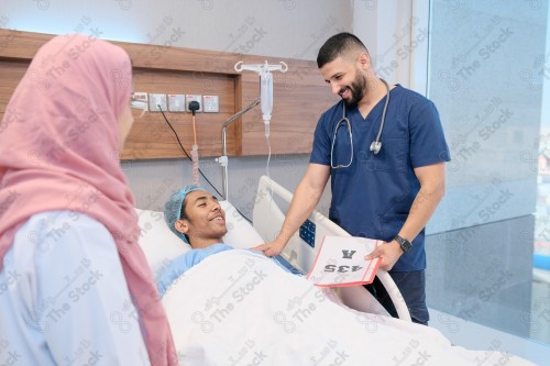 Saudi female doctor and paramedic in medical uniform and examining and applying nutritional solution, medicine and health care