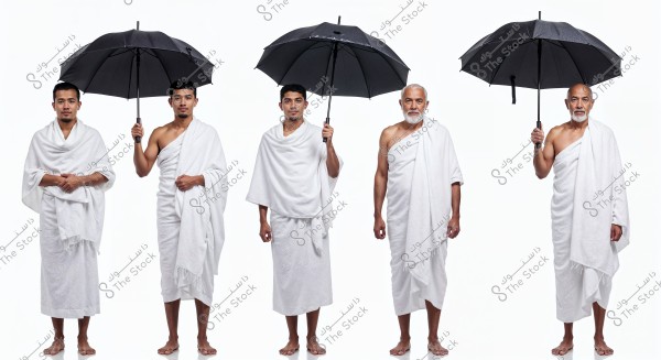 Image of five men wearing a white ihram, consisting of two pieces, standing side by side against a white background. Three of them are holding black umbrellas. The ihram is traditional attire worn during Hajj in Islam.