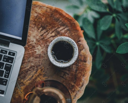 A shot of a cup of coffee on a wooden table, hot drinks.