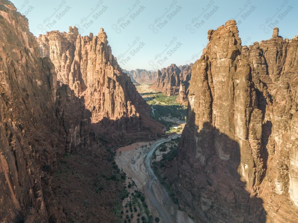 An aerial shot of Wadi Al-Disa in Tabuk, showing the mountains during the day, Saudi valleys, and nature in Saudi Arabia.