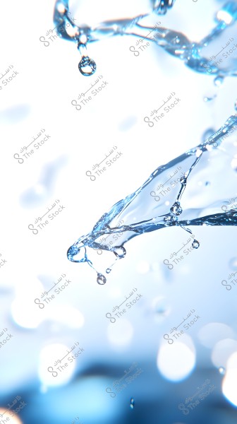 A close-up image of transparent water droplets clustered against a light-colored background with a bluish tint. The droplets are scattered randomly in the image, appearing to be in motion, with light reflections adding shine and highlighting their transparent details.