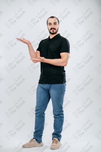 Portrait of a Saudi man on a white background making hand gestures while smiling, souvenir photos, documenting a happy moment