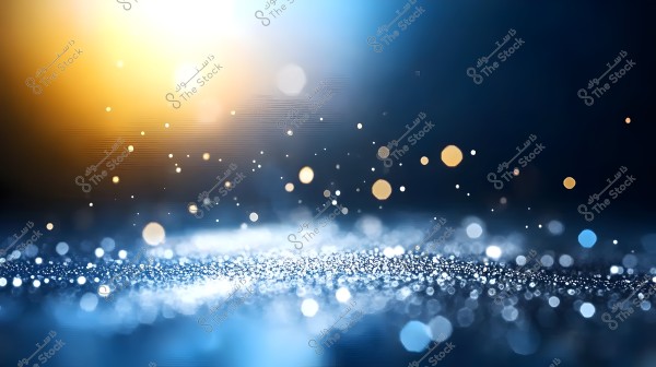 تظهر الصورة خلفية تجريدية تتكون من نقاط ضوئية متلألئة بألوان زرقاء وبرتقالية على خلفية داكنة. تتميز الصورة بتباين مشرق وتدرجات ناعمة للون, مما يخلق إحساسًا بالهدوء والجمال.