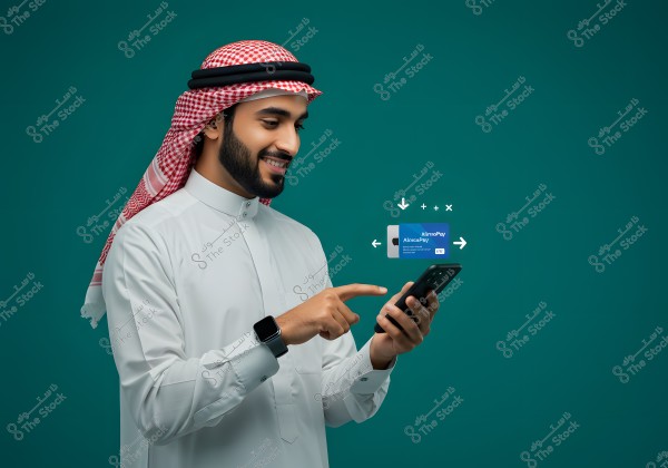 An image of a smiling man wearing a white thobe and a red-checkered headscarf with an agal, using a smartphone. A digital payment card appears next to him with icons depicting data exchange, all set against a green background.