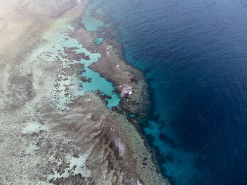 An aerial shot of the coral reefs in Shuaiba, on one of the beaches in Jeddah. Clear sea water.