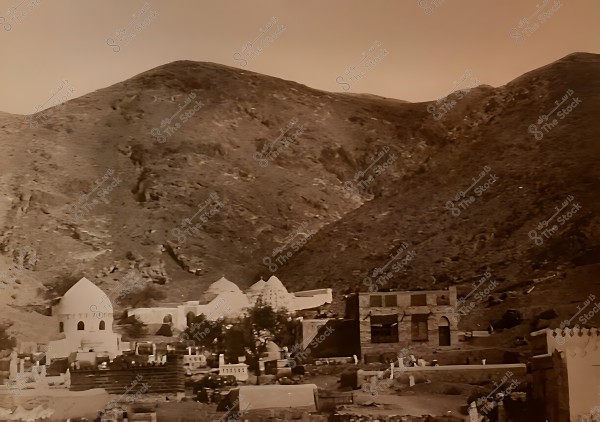 An old photo of mecca nestled in mountains, featuring Tombs those of the parents of the prophet Muhammad.