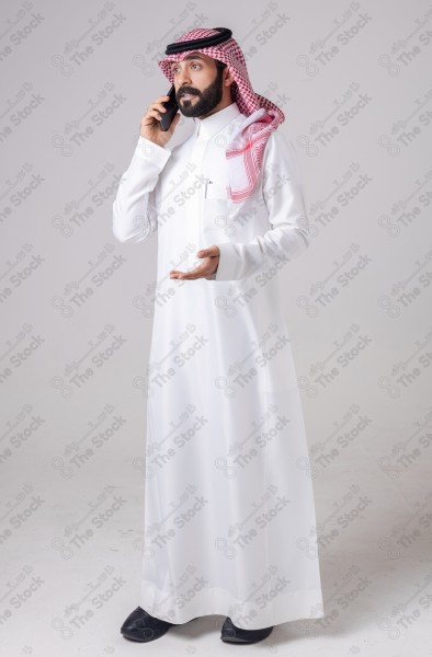 Portrait of a Saudi man holding a phone and making a phone call with different expressions