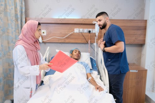 Saudi female doctor and paramedic in medical uniform and examining and applying nutritional solution, medicine and health care