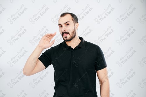 Portrait of a Saudi man on a white background making hand gestures while smiling, souvenir photos, documenting a happy moment