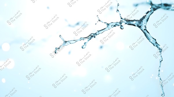 An image showing water splashes in the air against a light blue background. The droplets are scattered in various directions, focusing on the structure and transparency of the water.