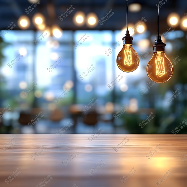 An image featuring two illuminated Edison-style bulbs hanging from the ceiling in an indoor setting. In the foreground, a smooth wooden surface is in focus, while the background is blurred, showing large windows with daylight streaming through, creating a calm and cozy atmosphere.