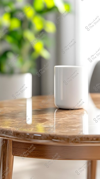 An image of a white mug placed on a glossy brown wooden table. In the background, blurred green leaves of plants are visible. Natural light highlights the details of the table and mug.