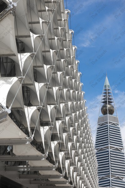 A shot of the King Fahd National Library and next to it the Al-Faisaliah Tower in the city of Riyadh, the capital of Saudi Arabia, skyscrapers, buildings and landmarks of the city of Riyadh