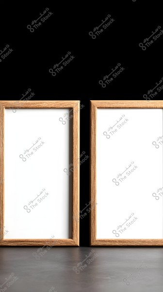 Two empty wooden-framed pictures placed side by side on a black surface with a black background. The frames are made of natural wood and stand out prominently against the black surface.