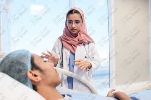 A Saudi female doctor wears a medical uniform and is examining and applying a nutrient solution, medicine and health care