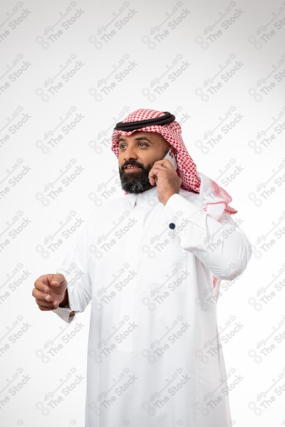 Portrait of a Saudi man holding a phone and making a phone call with different expressions