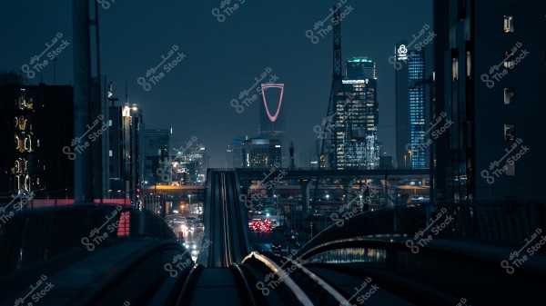 A nighttime scene of Riyadh city showing the Kingdom Tower lit in purple among skyscrapers and busy roads.