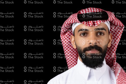 بورتريه رجل سعودي  يرتدي الزي السعودي الرسمي يقف على خلفية سوداء وهو ينظر إلى الكاميرا

رجل سعودي يقف مع خلفية سوداء