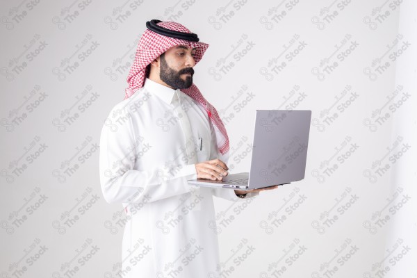 Portrait of a Saudi man holding a laptop and making different expressions, customer service, and communication.