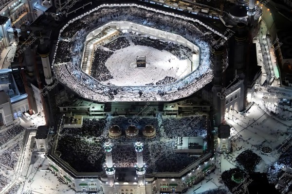 Aerial view of the Kaaba in the Grand Mosque in Mecca, showing thousands of worshippers performing Tawaf around the Kaaba.