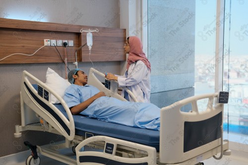 A Saudi female doctor wears a medical uniform and is examining and applying a nutrient solution, medicine and health care