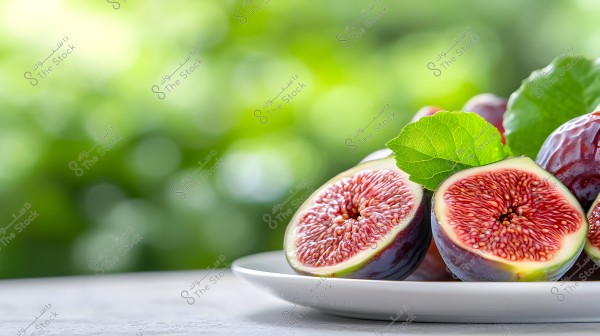 An image showing a white plate with three ripe figs cut in half. The inner details of the figs are visible with their vibrant red color and tiny seeds. Green leaves on some figs add a sense of freshness. The background is blurred with green hues, emphasizing the beauty and clarity of the figs in the foreground.
