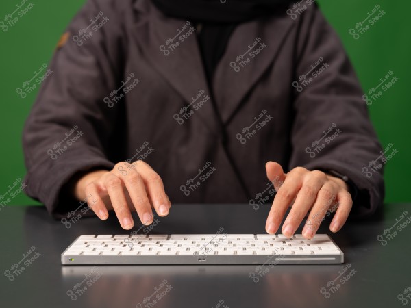 Person typing on a white keyboard