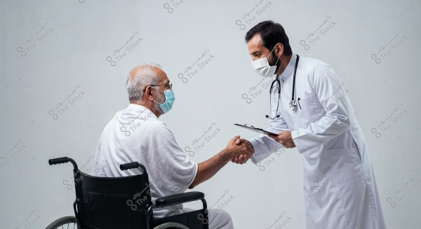 A doctor in a white coat and face mask greets an elderly patient seated in a wheelchair. Both are wearing medical masks. The doctor holds a clipboard and the patient is dressed in white attire. They appear to be in a medical conversation.