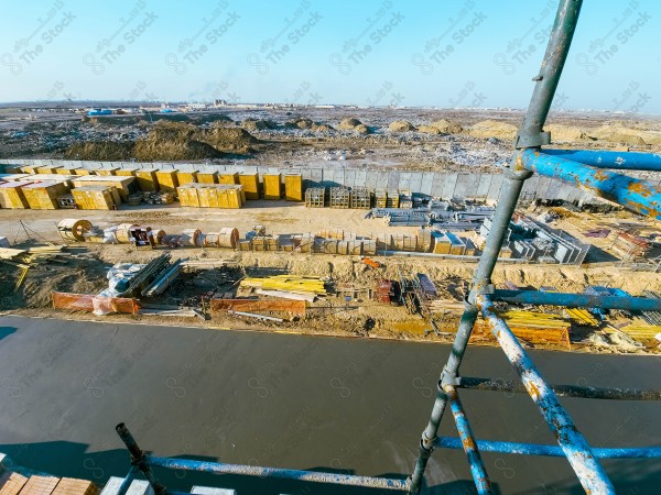 A construction site with a large building in the background. multi-storey building. A construction site with scaffolding and a large building in the background.