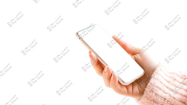 A hand holding a smartphone with a white screen, wearing a light pink knitted sweater. The background is bright white, drawing attention to the phone in the hand.