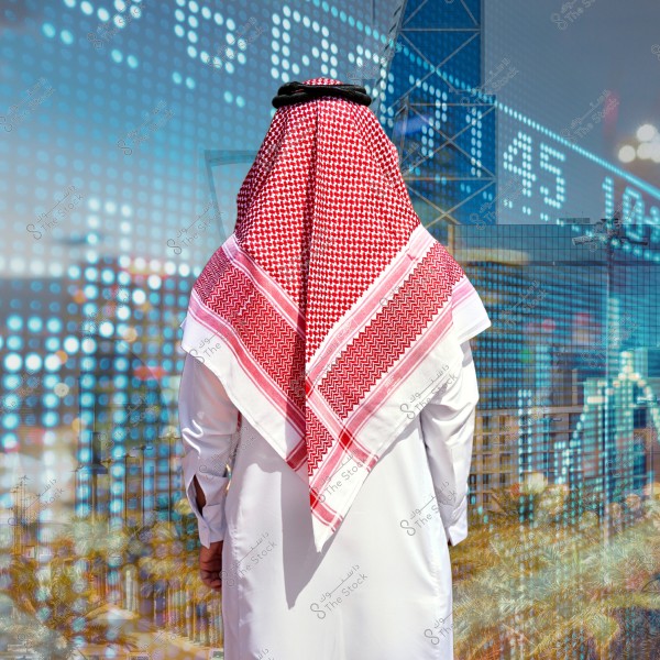 An image of a man wearing traditional Gulf attire, consisting of a white thobe and a red shemagh with an agal. The man is shown from behind standing in front of a background featuring a stock market index with illuminated numbers and images of modern skyscraper buildings.