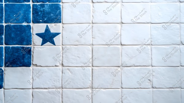 Image showing wall tiles with blue and white squares. On the left side of the image, there is a blue square with a white star. The rest of the tiles are plain white.