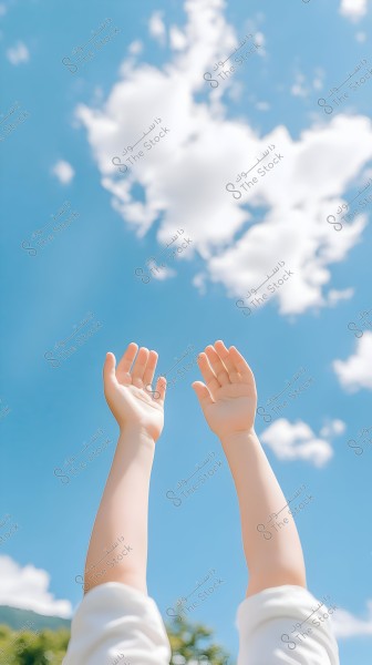 A clear blue sky with scattered white clouds, also showing a person\'s arms raised toward the sky. The white sleeves are visible, giving a sense of freedom and reaching out.