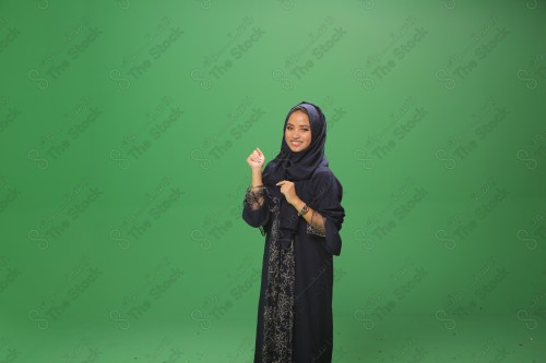 Portrait of a smiling Saudi girl wearing an abaya