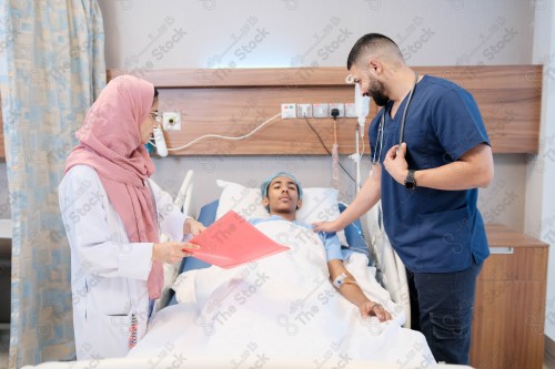 Saudi female doctor and paramedic in medical uniform and examining and applying nutritional solution, medicine and health care