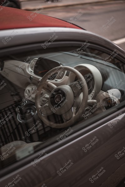 Interior cabin of a small car showing the steering wheel and interior details.