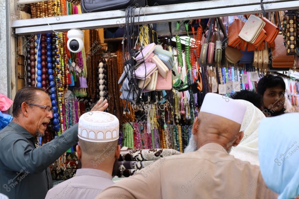 Mecca, Saudi Arabia - March 12 2025: people buying products from market shop in Mecca close to Masjid al-Haram, pilgrims umrah shopping in Makkah
