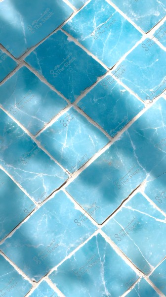 The image shows a series of light blue, glossy tiles arranged diagonally. The tiles have fine white cracks, giving them a natural and appealing appearance. The tiles are in a neat grid pattern with some soft shadows crossing over them.