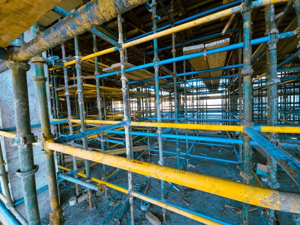 A construction site with a large building in the background. multi-storey building. A construction site with scaffolding and a large building in the background.