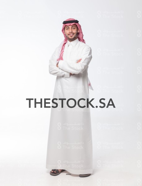 Portrait Saudi man standing on a white background wearing thoub, a photo of a smiling Saudi man