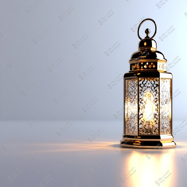 Image of a traditional metal lantern with decorative designs, illuminated from within, casting a light pattern on the white surface in the background. The lantern has an Eastern style and appears shiny with light reflections on its metallic surface.