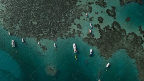 An overhead view of a group of boats in the Sea، Fishing boats above the surface of the water. sea ​​water .