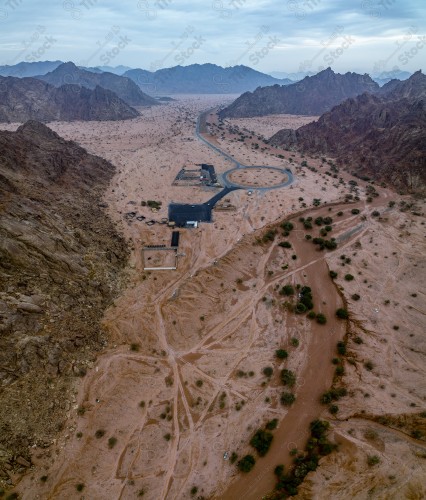 An overhead view of the construction of a temple street in the middle of a series of rocky mountains in Bidah/Al-Jin valley in Medina