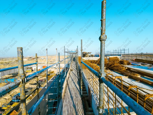 A construction site with a large building in the background. multi-storey building. A construction site with scaffolding and a large building in the background.