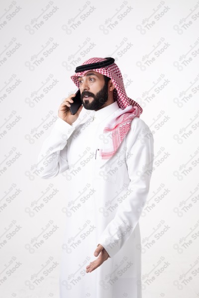 Portrait of a Saudi man holding a phone and making a phone call with different expressions